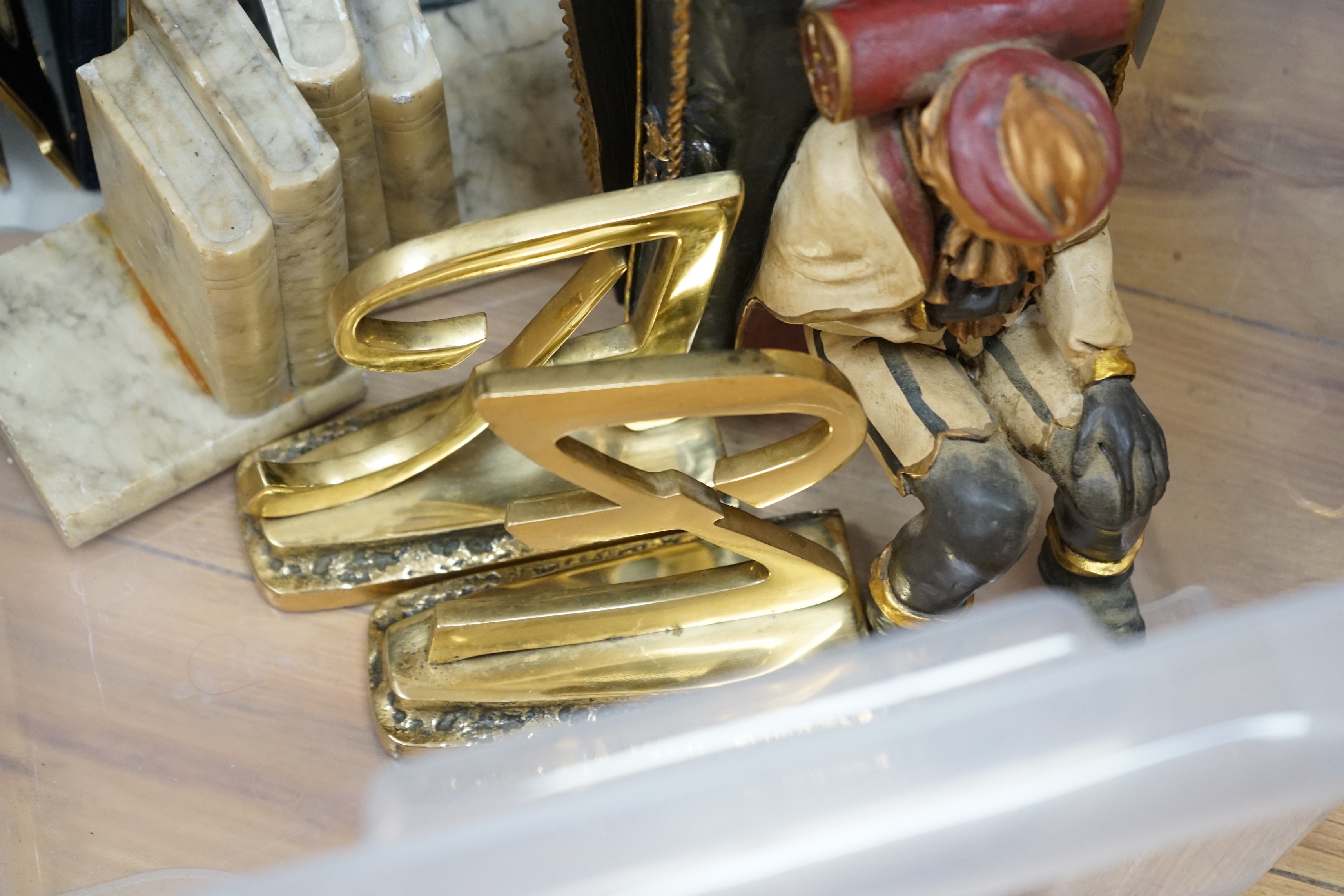 Various pairs of bookends and three photograph frames